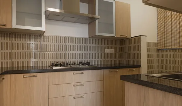 Representative impression of an apartment kitchen with counter and overhead storage; kitchen specification awaited