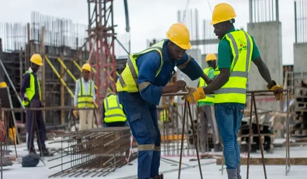Site engineers reviewing construction progress, representing the development timeline of a residential township